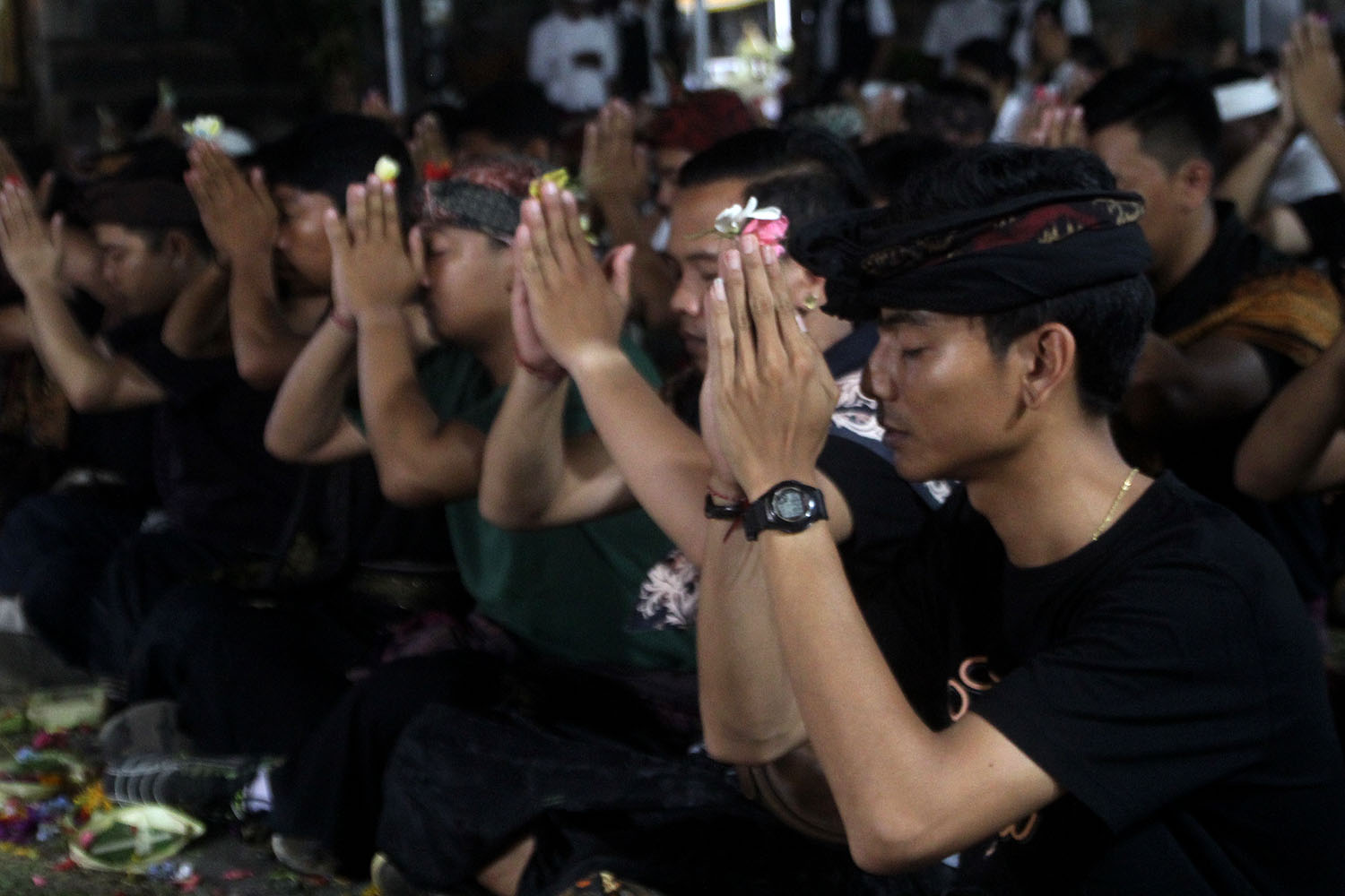 Prior to taking part in the tradition, the young men pray for safety at Dalam Kayangan Temple, Tuban village, Kuta, Badung, Bali, on Sunday, Oct. 13. JP/Zul Trio Anggono