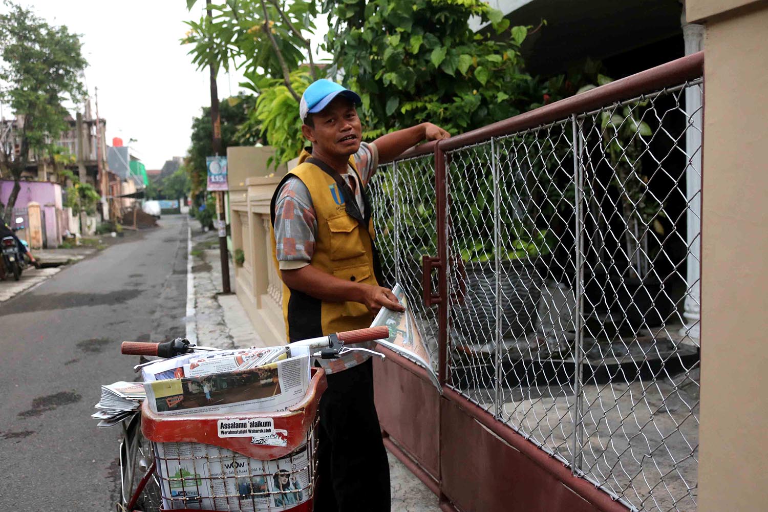 A deliveryman goes about his daily duties with a smile. JP/Maksum Nur Fauzan