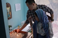 Illuminate the world: Orthodox Church members light candles at the Janasuci Petrus & Paulus Church in Tangerang. JP/ Taufan Wijaya