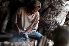 The artist sculpts bamboo roots into a variety of shapes and sizes.  JP/Magnus Hendratmo