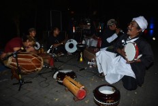 The performance's director, Jumali (right), 55, sings along with traditional music during the puppet show. JP/ Aman Rochman