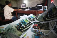 High demand: Photographs are printed on a number of printers to ensure speedy service. JP/Boy T Harjanto