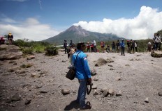 At your service: A Mount Merapi tourism photographer waits for the right moment to take pictures of tourists. No waste: Used syringes are used to inject ink into printer ink cartridges. High demand: Photographs are printed on a number of printers to ensure speedy service. Take your pick: As printed photographs are displayed, tourists promptly choose the ones they wish to buy. JP/Boy T Harjanto