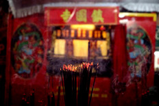 Front and center: Wisps of incense smoke twist in front of the wayang potehi (glove puppet) stage. JP/Maksum Nur Fauzan