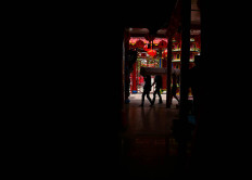 Candles, donated by residents, are carried by workers for the Chinese New Year celebration. JP/Bismo Agung