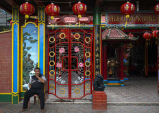 A resident who works as the temple’s caretaker sits in front the Hok Lay Kiong temple on Jan. 24. JP/Bismo Agung