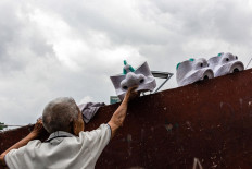 Work in process: Doel puts out barongsai lion heads to be dried in the sun. JP/Anggertimur Lanang Tinarbuko