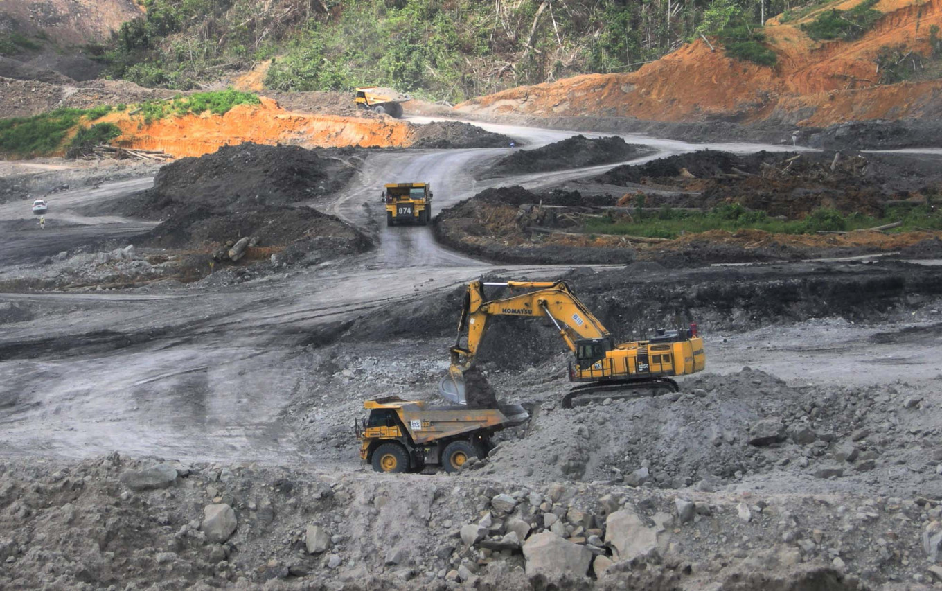 Heavy equipment owned by PT Berau Coal is used for coal mining activities at the Binungan mining site in East Kalimantan.
