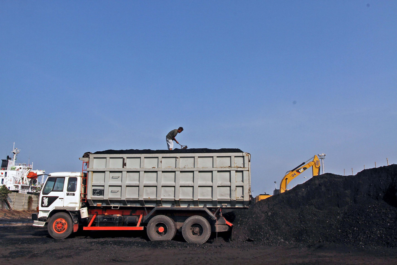 A worker loads coal at the port of Cirebon, West Java, in this file photo.