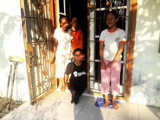 Family ties: Yoga poses for a photograph with his mother and sisters at his house in Tembung in Deli Serdang, North Sumatera. JP/Nurni Sulaiman