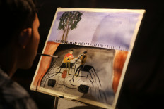 Delicate touch: Ahmad “Yoga” Prayoga paints using his mouth. He has plans to hold an exhibition this year. JP/Nurni Sulaiman