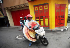 A man carries a Chinese-themed accessory. JP/Boy T Harjanto