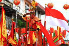 A tatung stands on a float embellished with an Indonesian flag. JP/HS Putra