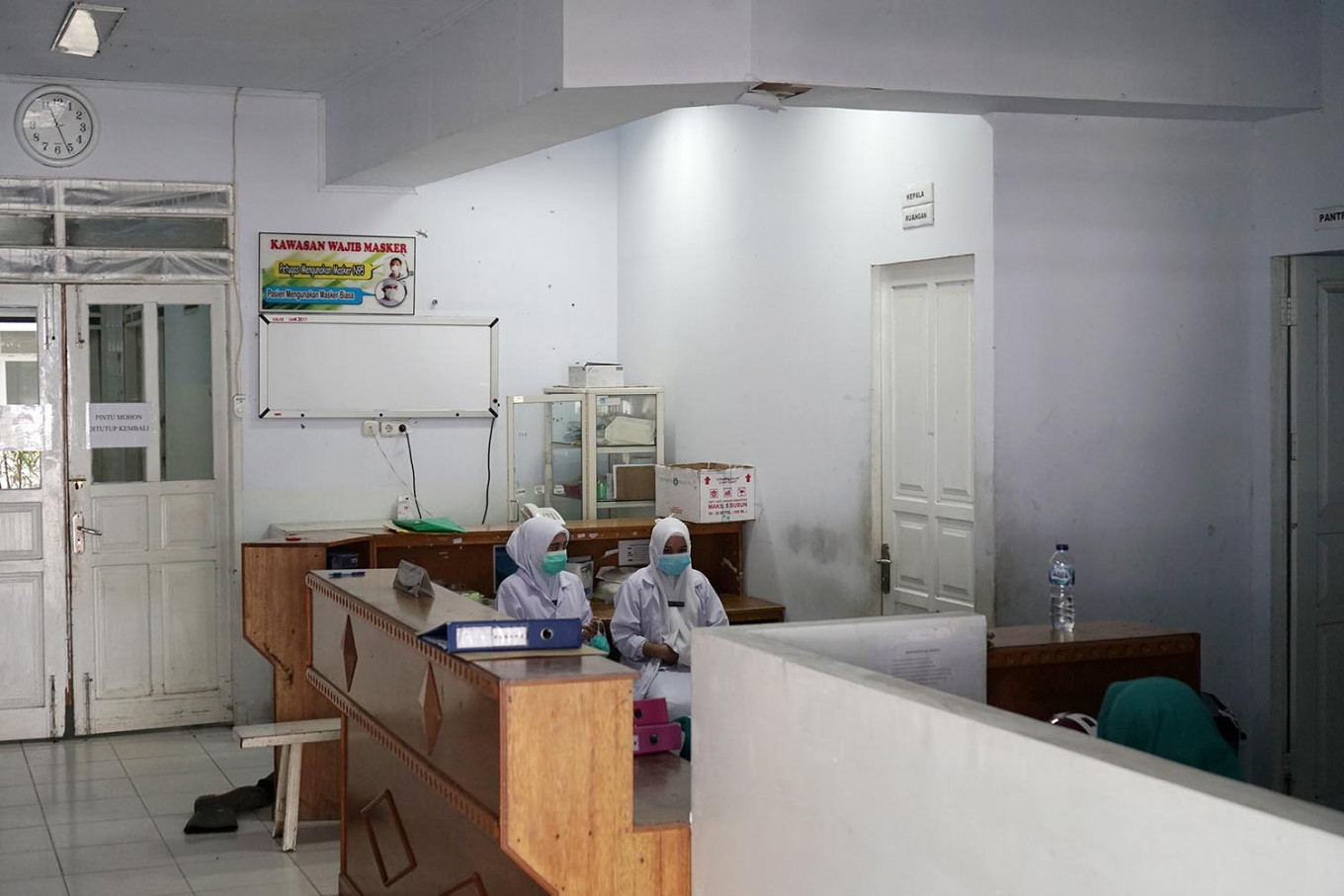 Two nurses sit inside the G4 building at the Aloei Saboe Regional General Hospital in Gorontalo City, Gorontalo, on Tuesday, March 3, 2020. The hospital is a referral hospital for coronavirus patients in the province.