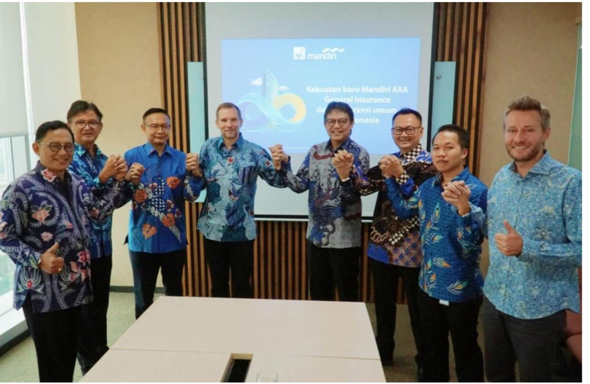 Mandiri AXA General Insurance (MAGI) compliance director Benny Waworuntu (third from the right) holds hands with other MAGI directors and comissioners in Jakarta on Dec. 2, 2019.