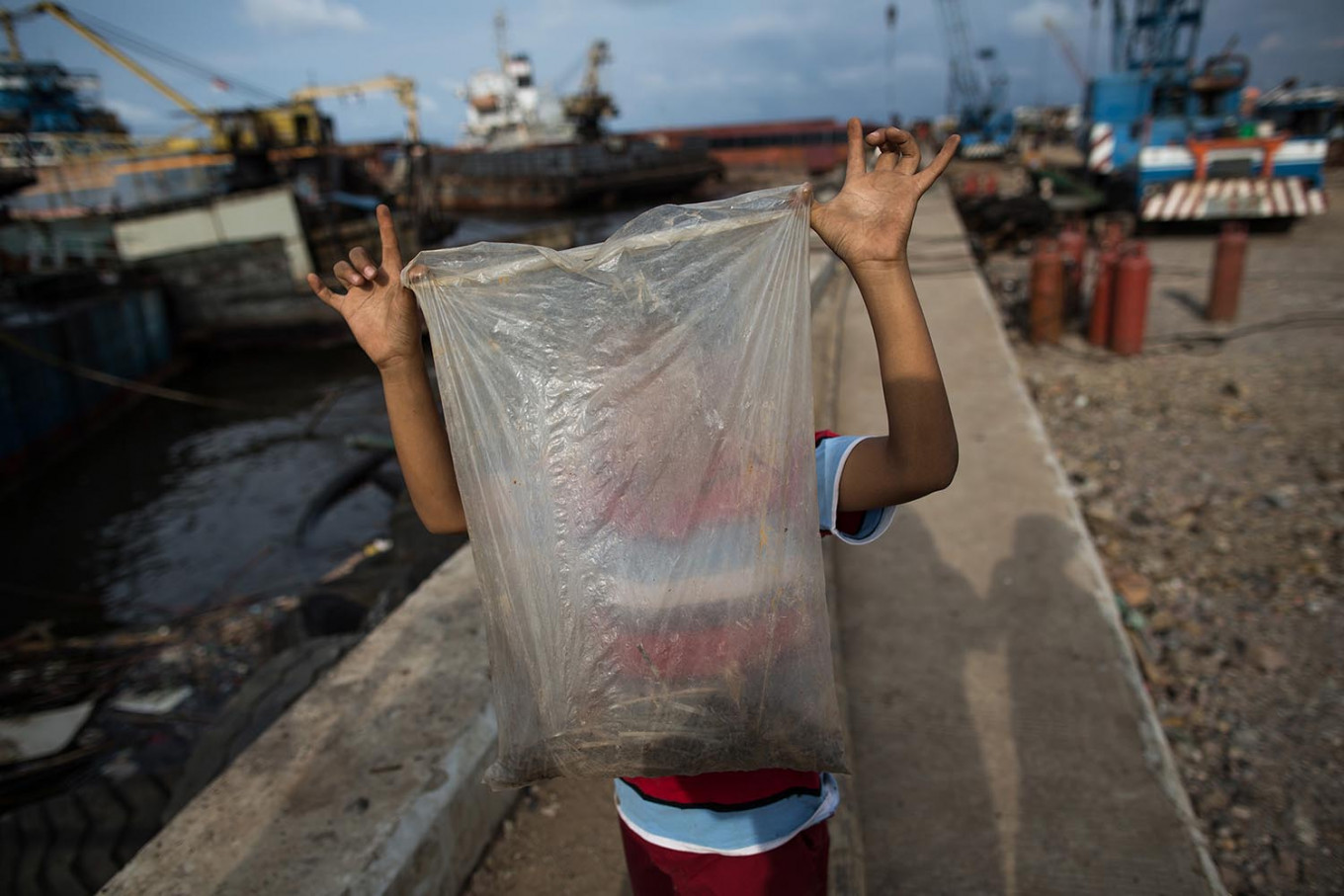 Ferrous fortune: A boy who works as a scrap iron collector shows the nuts and bolts he gathered from a dismantled ship. JP/Afriadi Hikmal