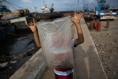 Ferrous fortune: A boy who works as a scrap iron collector shows the nuts and bolts he gathered from a dismantled ship. JP/Afriadi Hikmal