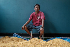 Tempe artisan Noerhakim, better known as Hakim, sits in front of piles of soybeans at his home in Singaraja, Buleleng regency, Bali. JP/ Anggara Mahendra
