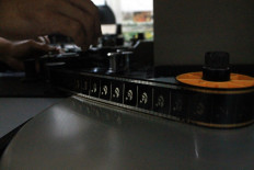 Analog technology: Celluloid film is threaded through an editing machine. JP/Xena Olivia
