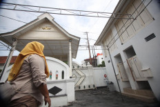 A woman walks inside the mosque complex. JP/Boy T Harjanto
