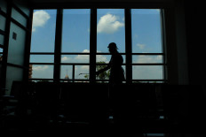 A staff member sprays disinfectant inside the Soelastri Dental Hospital (RSGM Soelastri) in Surakarta, Central Java. JP/Fauzan