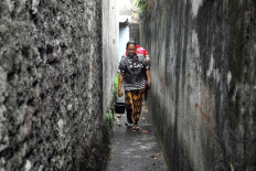 Handayani walks in a narrow alley in Pesanggrahan, South Jakarta. JP/Rahmat Dian Prasanto