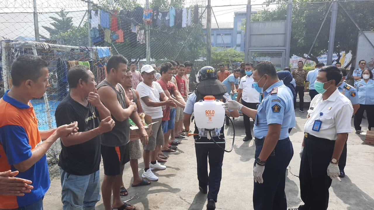 Prison officials spray disinfectant on inmates in Tanjung Gusta Penitentiary in Medan, North Sumatra, on March 23, 2020, to prevent the spread of COVID-19 in the overcrowded prison.