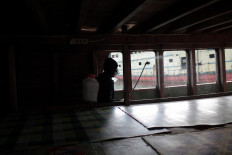 After all the passengers are cleared, a disinfectant worker sprays the boat’s cabin. JP/ Edy Susanto