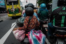 Mukinem and Satinem return to their home by motorcycle.  JP/Anggertimur Lanang Tinarbuko