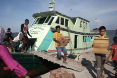 Wooden boats support the local economy by transporting goods between the islands. JP/Edy Susanto