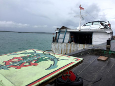 Wooden boats can carry large items like motorcycles and cars. JP/Edy Susanto