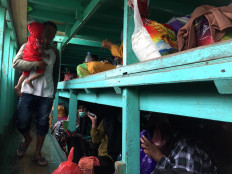 Passengers sit on wooden boards in the cabin. JP/Edy Susanto