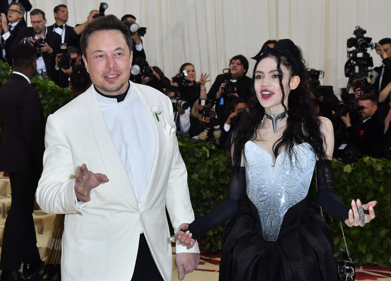 In this file photo taken on May 7, 2018 Elon Musk and Grimes arrive for the 2018 Met Gala, at the Metropolitan Museum of Art in New York.