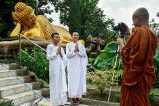 Two samanera (novice monks) participate in the making of a video for Waisak at the Dhammadipa Arama Vihara, Batu city, East Java, on May 5. This year's Waisak was celebrated without devotees crowding monasteries. Many stayed indoors and worshipped from home. JP/Aman Rochman 