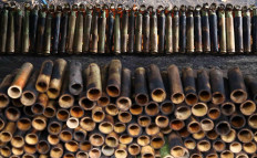 Bamboo tubes are piled beside the open fire. JP/P.J.Leo
