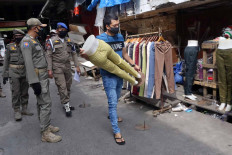 Satpol PP officers order sellers to close down their stores in Tanah Abang, Central Jakarta on Wednesday May 27. JP/Dhoni Setiawan