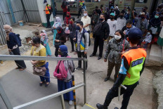 Commuters maintain a safe distance while waiting for their train at the Manggarai station in Jakarta on May 26. JP/Wendra Ajistyatama