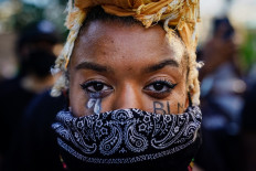 A woman with 'BLM' written on her cheek poses for a picture during a demonstration on May 
31, 2020 in Atlanta, Georgia. Across the country, protests have erupted following the recent death of George Floyd while in police custody in Minneapolis, Minnesota. AFP/Getty Images/Elijah Nouvelage