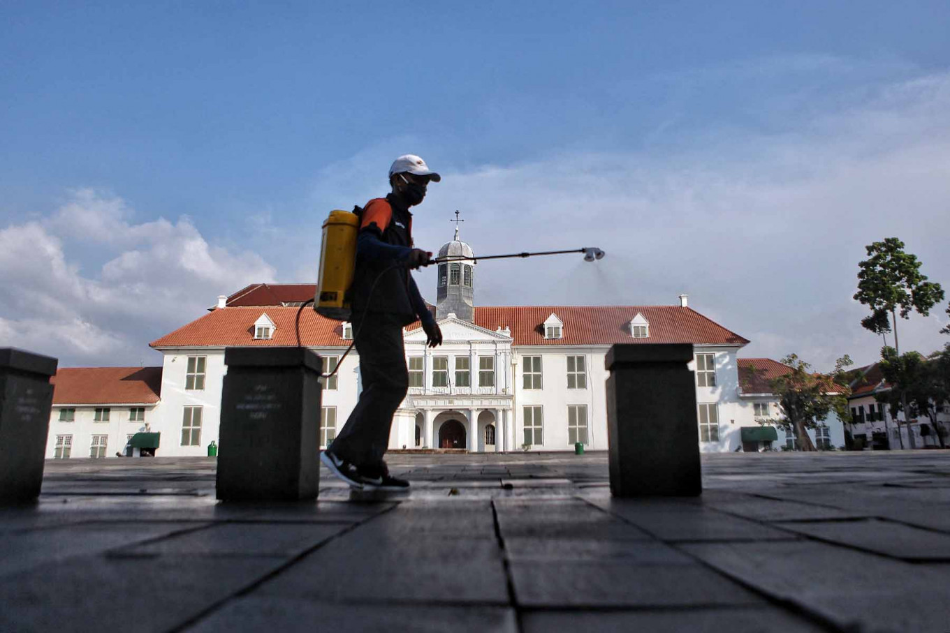 A worker disinfects Fatahillah Square in front of the closed Jakarta History Museum in the popular tourist area of Kota Tua, West Jakarta, on Tuesday. JP/Seto Wardhana