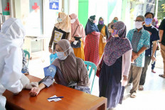 A nurse takes the blood pressure of a woman on Wednesday at the Puskesmas Citeureup in Bogor regency, West Java. The community health center is maintaining strict health protocols for both inpatient and outpatient care as a safeguard against COVID-19 transmission.  JP/P.J. Leo