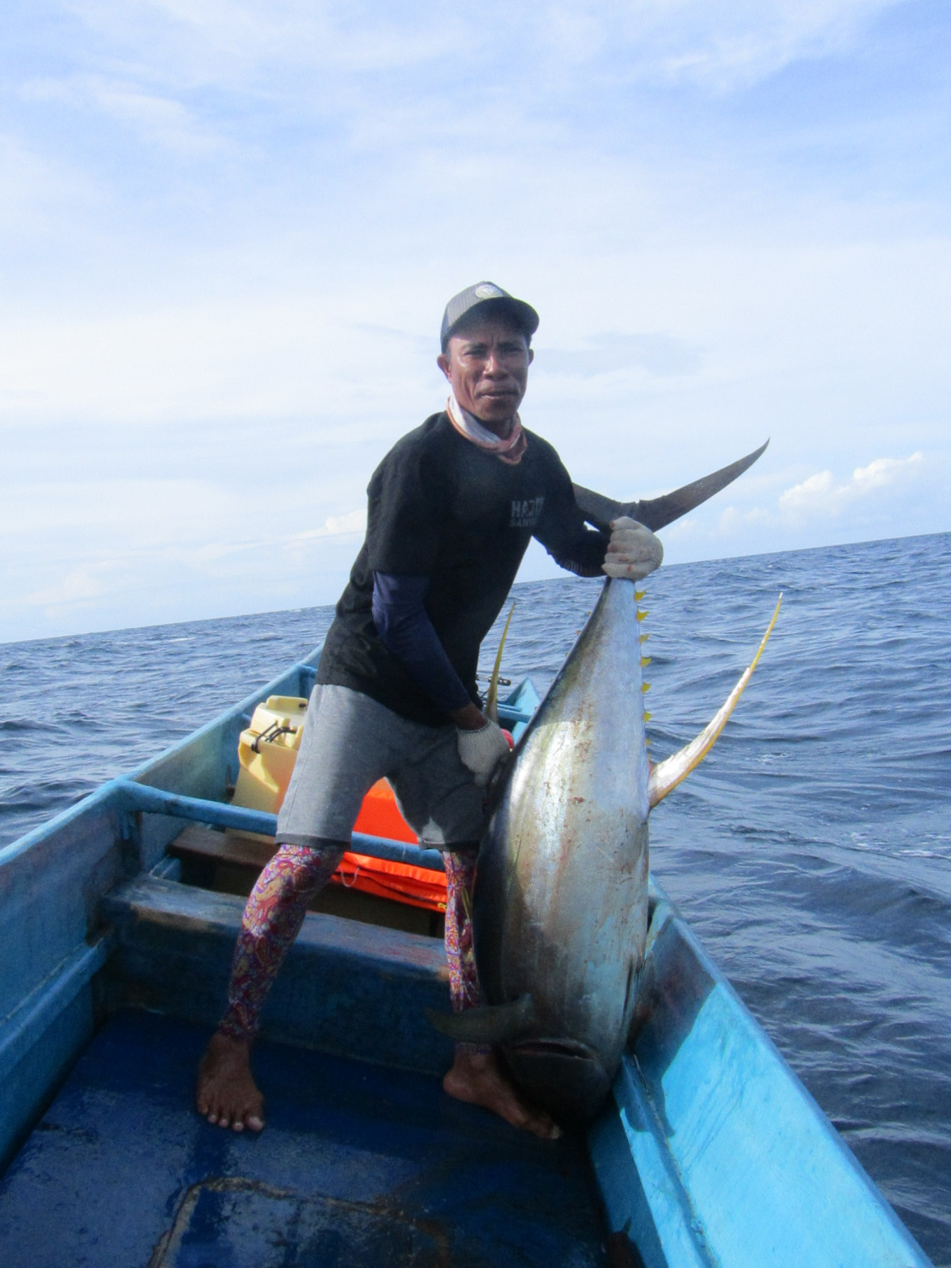 A fisherman from Waprea village, Buru regency, Maluku, Yusran Tomia, shows off his catch, a large yellowfin tuna. Fishermen from Buru Island have set an example for other small-scale fisheries in Indonesia and around the world that sustainable fishing can improve the livelihoods of fishing communities as the global community celebrates World Oceans Day on June 8.