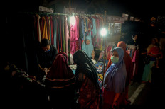 Women gather at a clothing kiosk on the sidewalk of a Pariaman street. JP/Arif Rahman AS