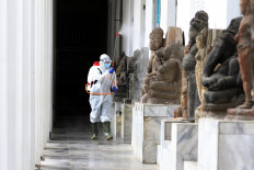 A staff member sprays disinfectant in the hallway of the National Museum in Jakarta on June 8. JP/Dhoni Setiawan