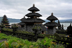 This picture taken on February 20, 2020 show a Balinese temple on the shores of Lake Batur near the village of Trunyan, home to the Trunyanese - who fuse animist beliefs and traditional village customs with their own interpretation of Hinduism - in Bangli Regency on Indonesia's Bali island. - For centuries Bali's Trunyanese people have left their dead to decompose in the open air, the bodies placed in bamboo cages until only the skeletons remain -- a ritual they haven't given up -- even as the COVID-19 pandemic upends burial practices worldwide.  AFP/Sonny Tumbelaka