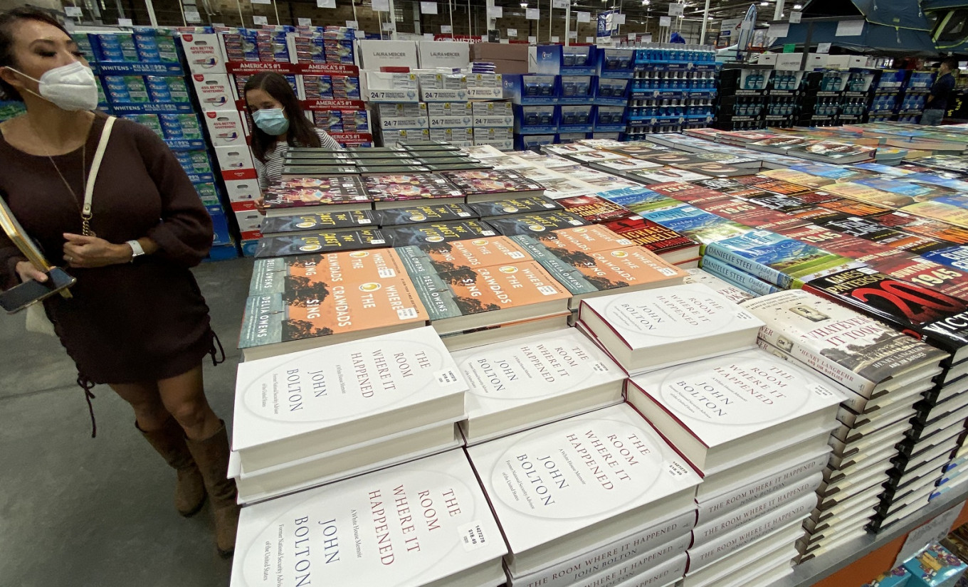 A woman looks over at copies of the book(R) 'The Room Where it Happened' a memoir by John Bolton at Costco in Marina del Rey, California on June 23, 2020. 