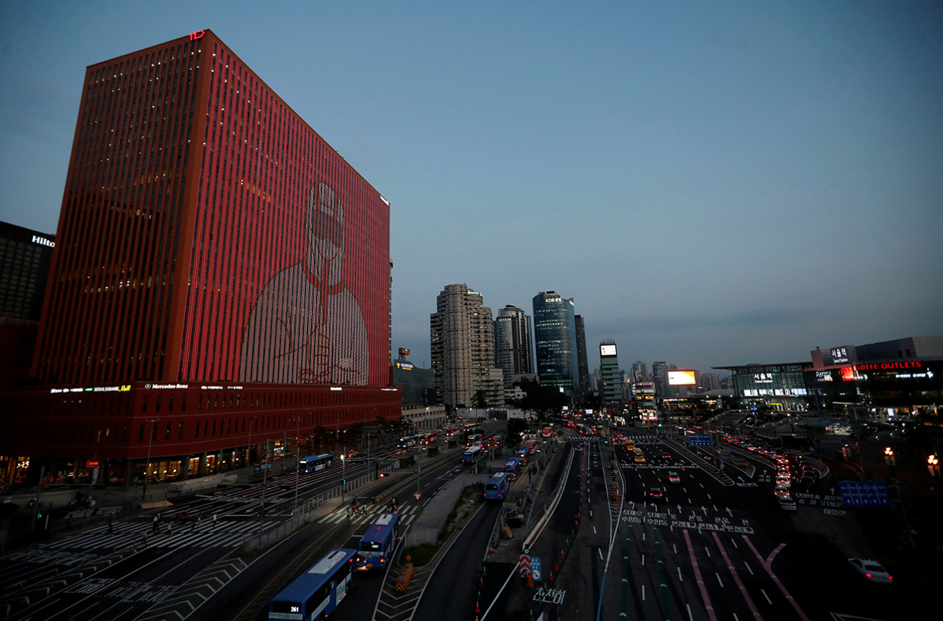 The exterior of a building is illuminated showing messages to support the country, as measures to avoid the spread of the COVID-19 continue, in Seoul, South Korea, July 7, 2020.Even with unemployment spiking as the coronavirus pandemic swept South Korea in February, Baek Seung-min asked his wife to quit her nursing job to help reach a dream they had spent a lifetime chasing: buying their own apartment.
