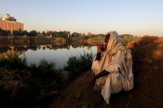 Mohamed Ahmed al Ameen, 55, a brick maker, drinks a cup of tea as he sits on the edge of the Blue Nile near an open-air factory on Tuti Island, Khartoum, Sudan, February 14, 2020. "I consider the Nile to be something that I have never parted with, ever since I was born", Ameen said. "I eat from it, I farm with it. I also extract these bricks from it ? My whole source of income is from the Nile." Reuters/Zohra Bensemra