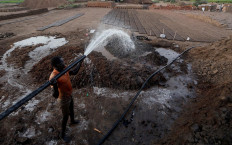 Zaki El-Dine, 24, a brick-maker, pours water from the Nile river onto a patch of mud to make bricks on Tuti Island, Khartoum, Sudan, February 12, 2020. Reuters/Zohra Bensemra