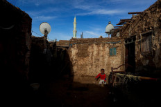 A boy plays in the courtyard outside of his home, which is made of mud and bricks, in Omdurman, Sudan, February 21, 2020. Reuters/Zohra Bensemra