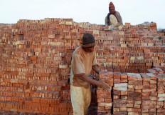 Mustapha, 60, a brick maker, piles up bricks after removing them from a kiln at an open-air factory on Tuti Island, Khartoum, Sudan, February 20, 2020. "I fear that we will not gain any advantage from the Dam that Ethiopia is building. I am not an expert but I think the amount of water as well as mud will decrease. We usually get the mud when the Nile overflows", said Mustapha.Reuters/Zohra Bensemra